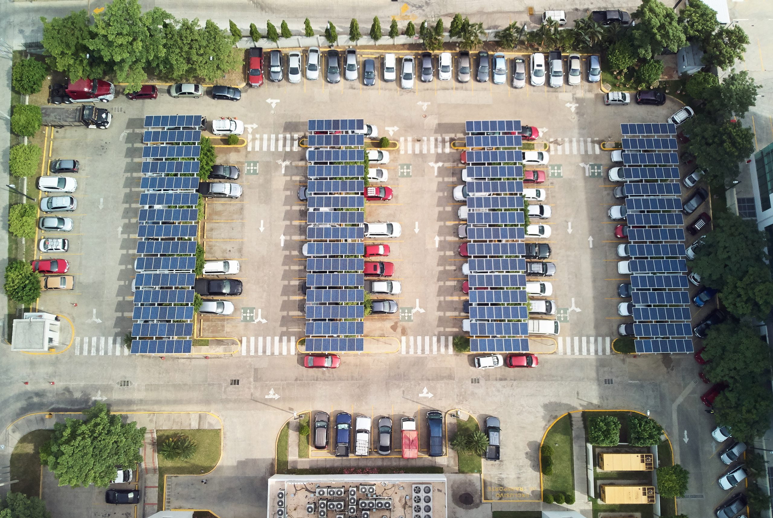 Parking lot with solar panels for charging cars above top view